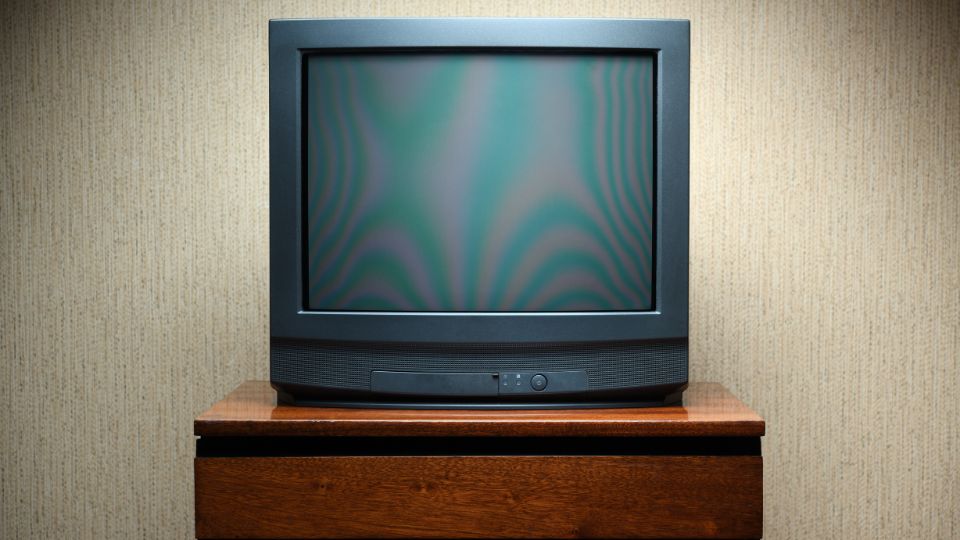 A photo of an old TV on a TV table