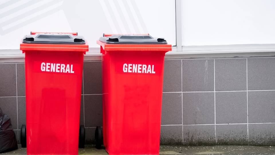 Two red general waste bins