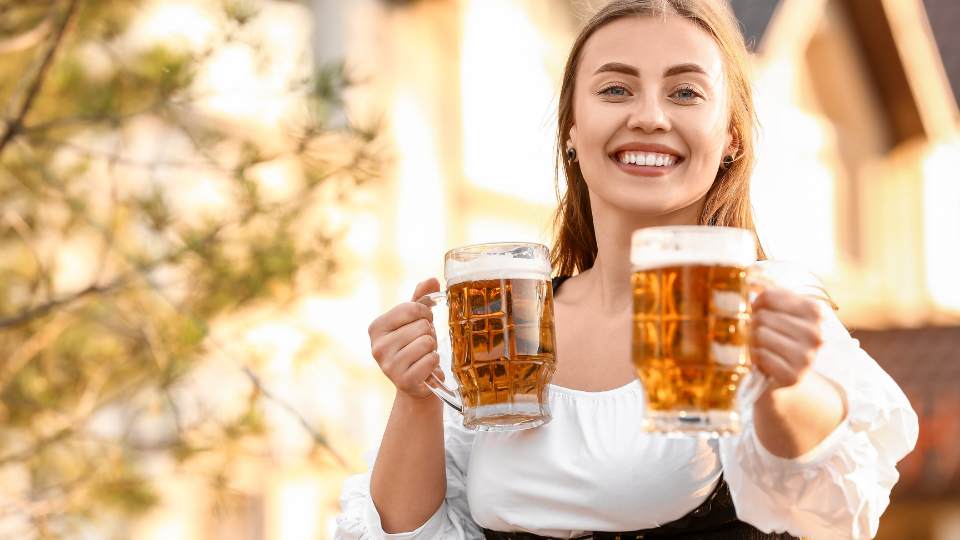 Woman holding up two beers