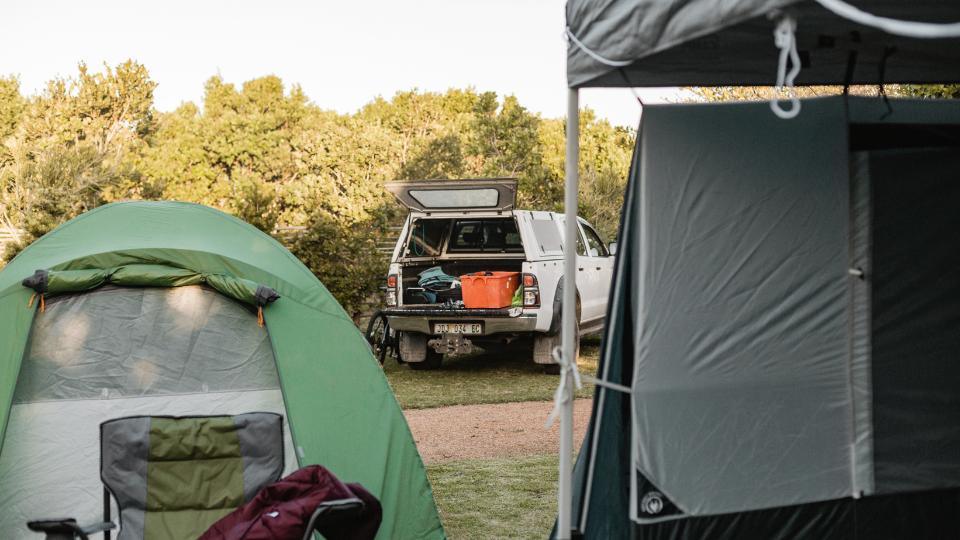 a campsite with campervans and tents