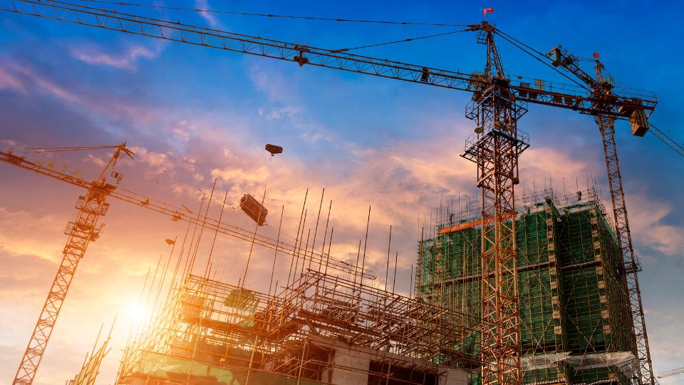 Crane carrying construction waste on building site