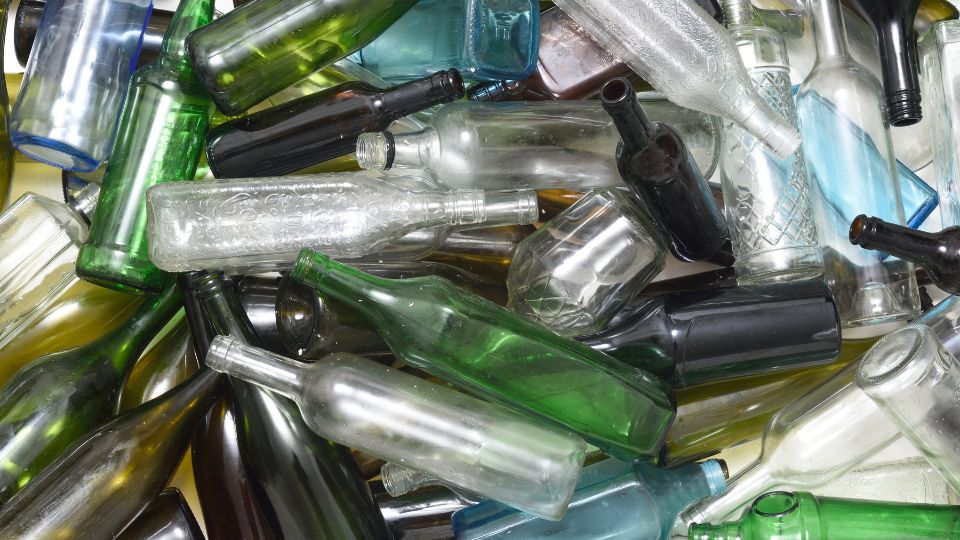 Photo of lots of glass bottles waiting to be recycled