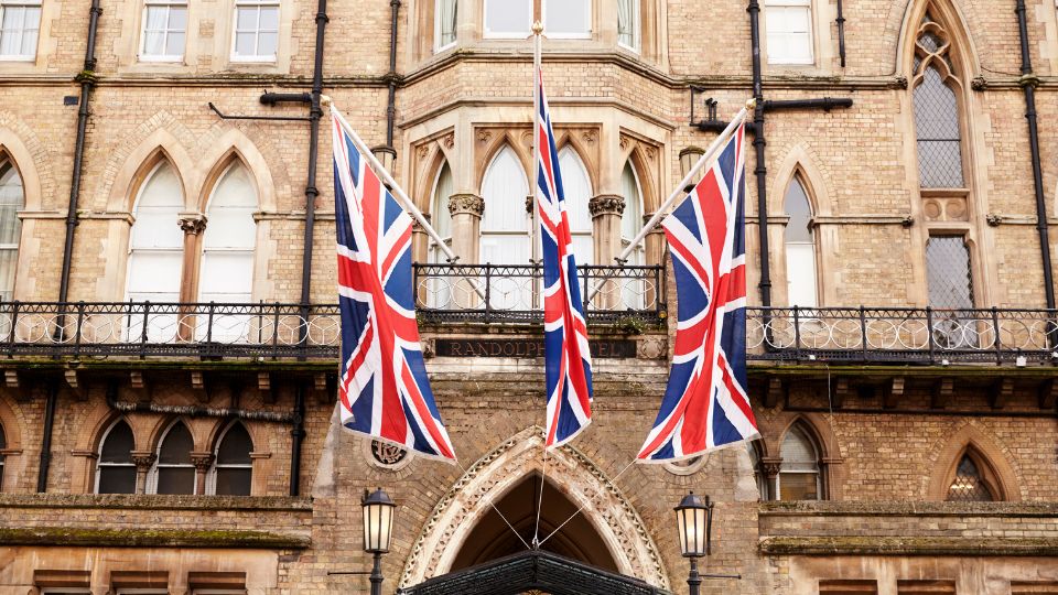 A photograph of the Randolph hotel in Oxford with Union Jack flags hanging outside.