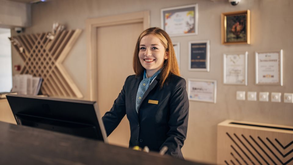 Concierge working at a hotel at reception desk