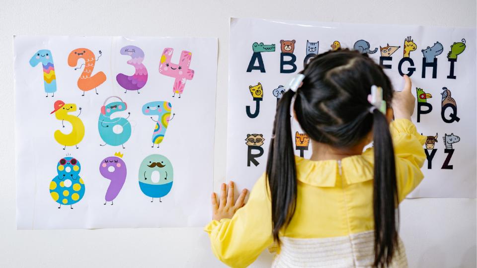 child at nursery looking at alphabet