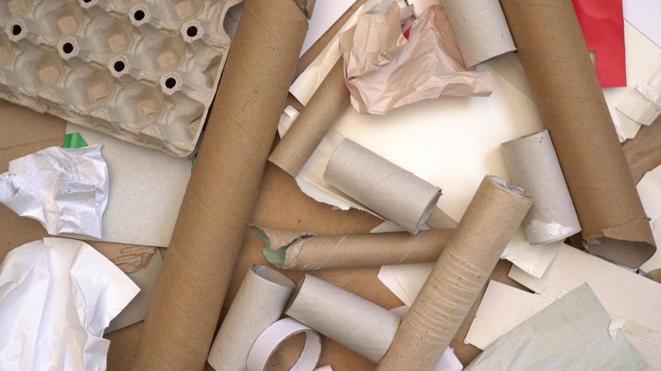 A photograph of dry mixed recycling materials including cardboard, tissue and paper and egg cartons.