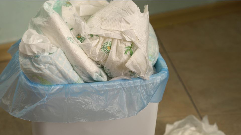 photograph of nappy waste in a sanitary waste bin in a bathroom