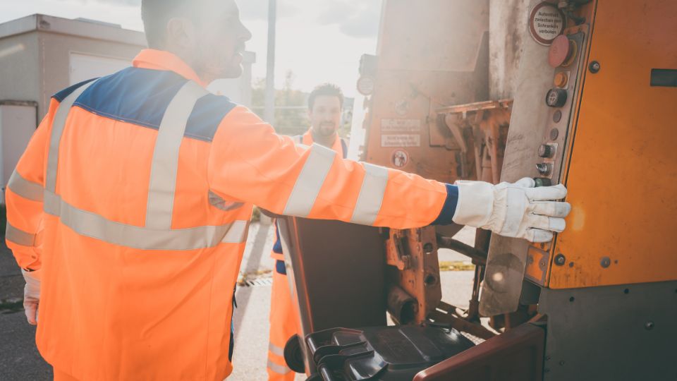 Waste collectors filling up a truck