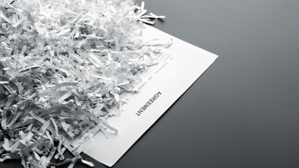 Confidential commercial agreement being shredded