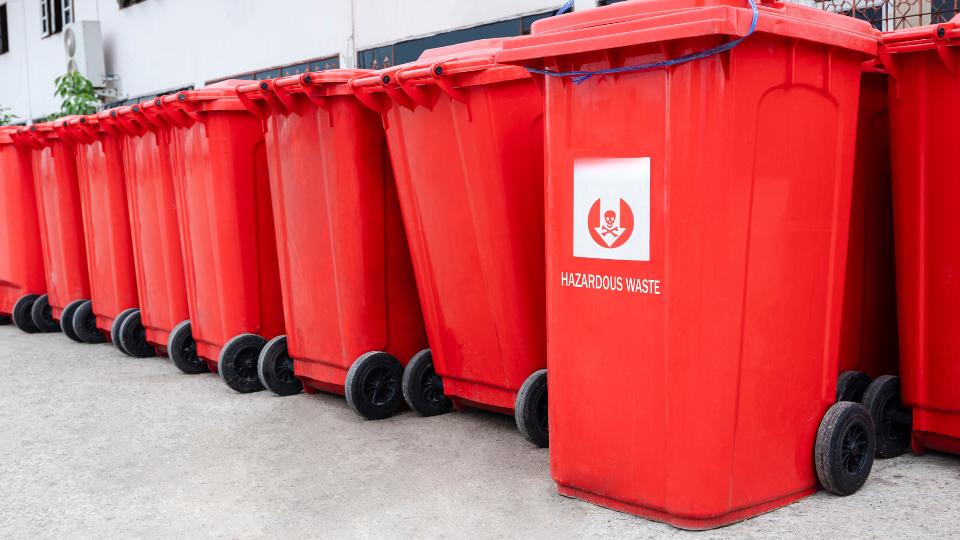 Red hazardous waste wheelie bins