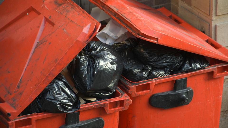 Large red dirty wheelie bins