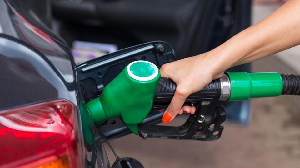 Woman filling up car with petrol