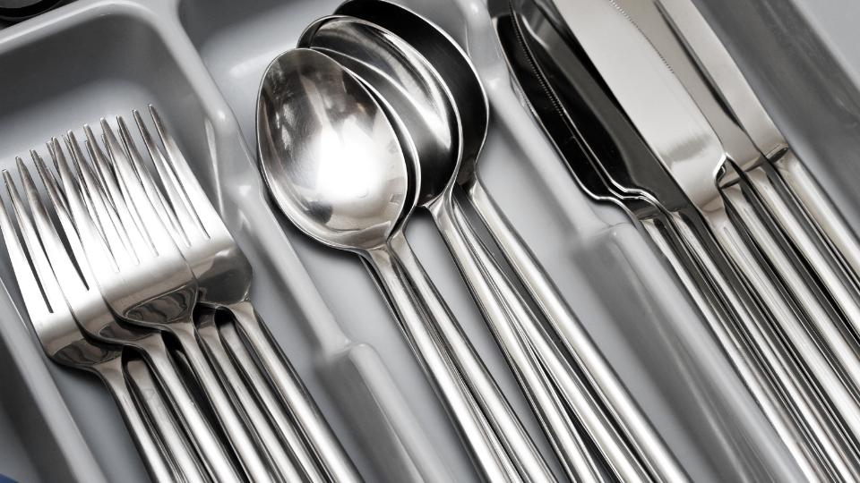 Silver metal cutlery in a drawer
