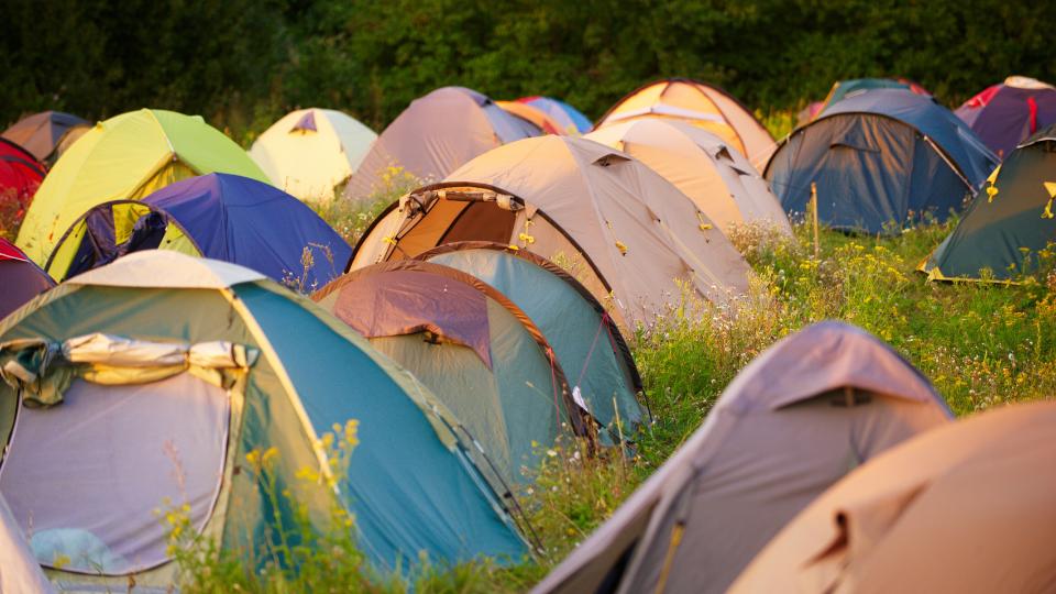 Tents at a festival in the sunset