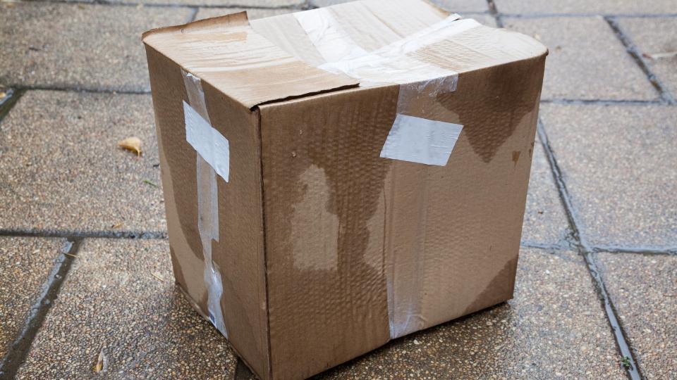 Wet cardboard box outside in the rain