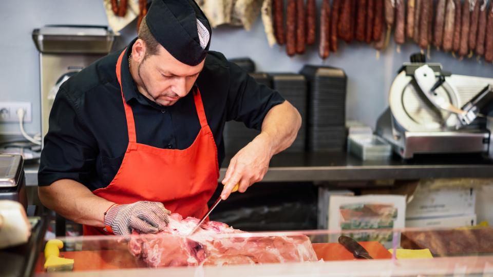 Butcher cutting meat