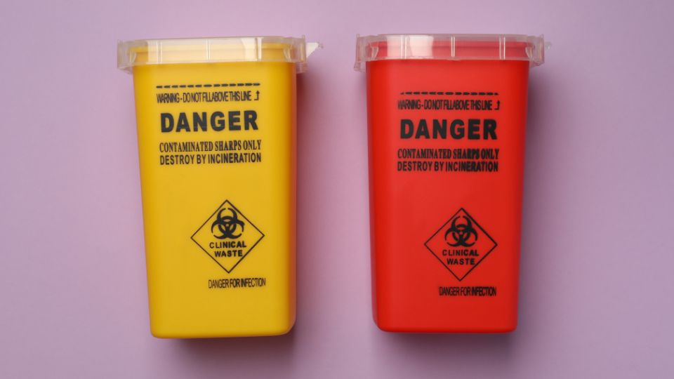 Yellow and red clinical waste sharps bins