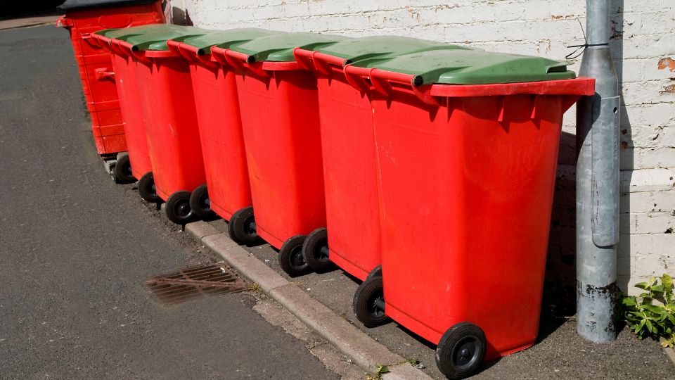 Red business wheelie bins outside a care home