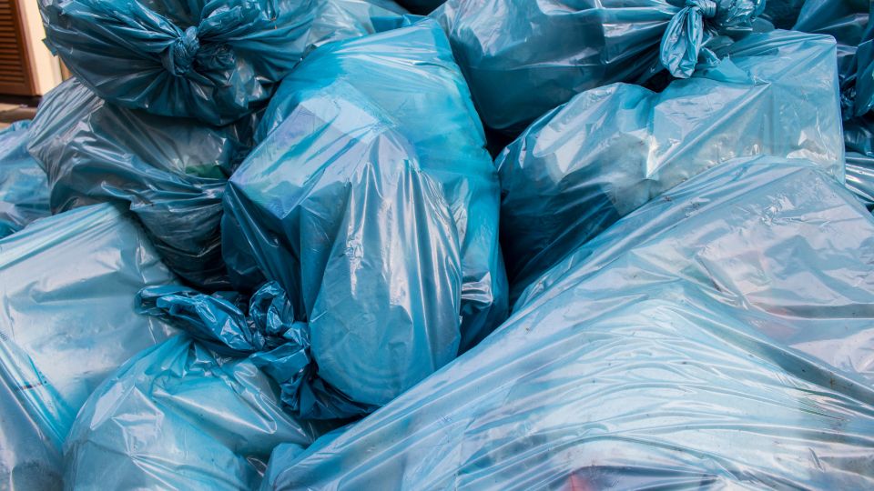 a photograph of blue industrial bin bags