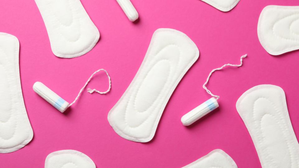 sanitary products like sanitary towels and tampons on a pink background