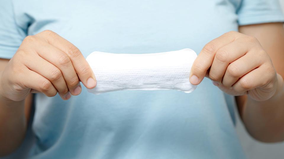 an employee holding a panty liner